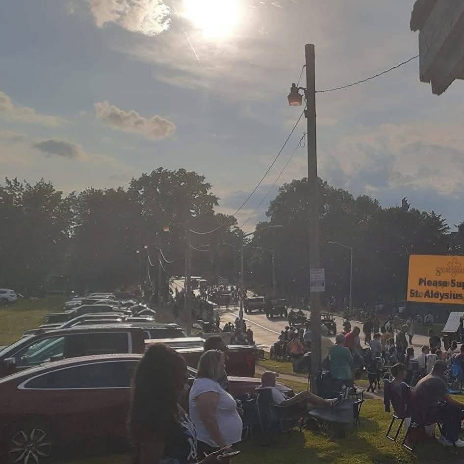 Cars parked near the Illinois State Fair at sunset